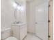 This bathroom has white walls, a white vanity, and a white door at 6233 N Liverpool St, Aurora, CO 80019