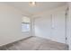 Bright bedroom featuring neutral carpeting and a window with modern blinds, enhancing natural light at 6233 N Liverpool St, Aurora, CO 80019