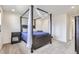 Bedroom showcasing a four-poster bed, soft carpet, and neutral color palette at 6233 N Liverpool St, Aurora, CO 80019