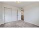 Bedroom featuring plush carpeting, a spacious closet, and a minimalist aesthetic at 6233 N Liverpool St, Aurora, CO 80019