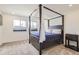 Elegant bedroom with four-poster bed, soft carpet, and bright natural light at 6233 N Liverpool St, Aurora, CO 80019