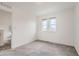 Airy bedroom with two bright windows, neutral carpeting, and a modern, minimalist style at 6233 N Liverpool St, Aurora, CO 80019
