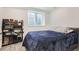 Cozy bedroom featuring neutral carpeting, a comfy bed, and a side rack for storage at 6233 N Liverpool St, Aurora, CO 80019