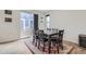 Bright dining room features a dark wood table and large sliding glass doors leading to outdoor living space at 6233 N Liverpool St, Aurora, CO 80019