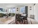 Open-concept dining area with modern table, LVP flooring, and seamlessly connected to the living space at 6233 N Liverpool St, Aurora, CO 80019