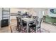 Open-concept dining and living area offers stylish furnishings and seamless flow, perfect for entertaining and modern living at 6233 N Liverpool St, Aurora, CO 80019