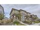 Charming two-story home showcasing its neutral color scheme, stone accents, and landscaped yard at 6233 N Liverpool St, Aurora, CO 80019