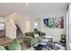 Comfortable living area with vinyl flooring, stylish seating, and a staircase to the upper level at 6233 N Liverpool St, Aurora, CO 80019