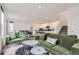 Spacious living area with stylish sofas, access to a kitchen, and a modern staircase at 6233 N Liverpool St, Aurora, CO 80019