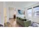 Inviting living room with LVP flooring, comfortable green sofa, and bright natural light at 6233 N Liverpool St, Aurora, CO 80019