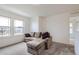 Bright living room featuring a comfortable sofa, neutral carpet, and a minimalist design at 6233 N Liverpool St, Aurora, CO 80019