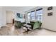 Open-concept living area with vinyl plank flooring, bright windows, and comfortable seating at 6233 N Liverpool St, Aurora, CO 80019