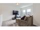 Cozy living room featuring neutral carpet, a comfortable sectional sofa, and ample natural light at 6233 N Liverpool St, Aurora, CO 80019