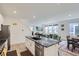 Open floor plan offers seamless transition from kitchen island to dining area, showcasing modern living at its finest at 6233 N Liverpool St, Aurora, CO 80019