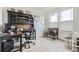 Bright home office offers ample workspace with built-in shelving and natural light, ideal for remote work or study at 6233 N Liverpool St, Aurora, CO 80019