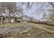 View of the backyard with a large retaining wall, stone stairs and lush landscaping at 2311 E 96Th Way, Thornton, CO 80229