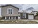Charming two-story home with a brick and vinyl exterior and well-maintained front yard at 2311 E 96Th Way, Thornton, CO 80229