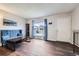 Bright living room with hardwood floors, a large window, and comfortable seating at 2311 E 96Th Way, Thornton, CO 80229