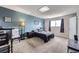 Spacious main bedroom with carpet floors, soothing blue walls, and a large window at 2311 E 96Th Way, Thornton, CO 80229