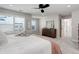This primary bedroom includes large windows, plush carpet and a ceiling fan at 431 Courtfield Way, Castle Pines, CO 80108