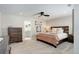 This bedroom features soft carpet, a ceiling fan, and a walk-in bathroom for a luxurious space at 431 Courtfield Way, Castle Pines, CO 80108