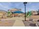 Community playground with tables and a blue gazebo provides hours of fun for everyone at 431 Courtfield Way, Castle Pines, CO 80108