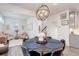 Bright dining area with a contemporary chandelier, seating for six, and a view into the adjacent living spaces at 431 Courtfield Way, Castle Pines, CO 80108