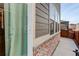 Exterior view showcasing a sliding glass door, neutral siding, and brick foundation at 431 Courtfield Way, Castle Pines, CO 80108