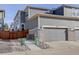 Exterior view of a gray home with a gray garage and rock landscaping at 431 Courtfield Way, Castle Pines, CO 80108