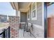 Cozy front porch with brick accents and seating, perfect for relaxing at 431 Courtfield Way, Castle Pines, CO 80108