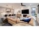 Contemporary living room featuring a fireplace with TV, an open kitchen with bar seating, and a comfortable seating area at 431 Courtfield Way, Castle Pines, CO 80108