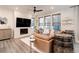Modern living room boasts a fireplace, large TV, and decorative wine barrel accents at 431 Courtfield Way, Castle Pines, CO 80108