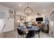 Stylish living space with an open kitchen, dining area, and a comfortable living room featuring a fireplace and TV at 431 Courtfield Way, Castle Pines, CO 80108