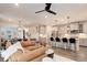 Open concept living space with modern kitchen and comfortable living room seating at 431 Courtfield Way, Castle Pines, CO 80108