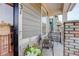 Inviting front porch with brick pillars, a cozy seating area, and decorative plants, perfect for relaxation at 431 Courtfield Way, Castle Pines, CO 80108