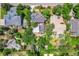 Aerial view of a property with mature trees, backyard, and solar panels at 1564 S Uinta Way, Denver, CO 80231