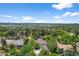 Expansive aerial view of a house with mature trees, lawn, and solar panels at 1564 S Uinta Way, Denver, CO 80231