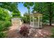 Charming backyard with a gazebo and storage shed, surrounded by mature trees at 1564 S Uinta Way, Denver, CO 80231