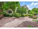 Inviting backyard featuring a birdbath, mature trees, and lush landscaping at 1564 S Uinta Way, Denver, CO 80231