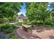 Backyard featuring benches around a fountain with landscaping and the exterior of the house at 1564 S Uinta Way, Denver, CO 80231