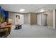 Finished basement area with neutral carpeting, recessed lighting, and a comfortable seating area at 1564 S Uinta Way, Denver, CO 80231