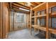 Unfinished basement with storage, framing, small window, and concrete floor at 1564 S Uinta Way, Denver, CO 80231