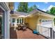 Outdoor deck features wood flooring, a table with chairs, and an umbrella at 1564 S Uinta Way, Denver, CO 80231