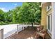 Outdoor deck features wood flooring, railing, and wicker seating at 1564 S Uinta Way, Denver, CO 80231