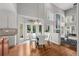 Open dining area with a modern round table, flowing into a living space with bright natural light at 1564 S Uinta Way, Denver, CO 80231