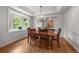 Traditional dining room featuring a wooden table set and a large window with natural light at 1564 S Uinta Way, Denver, CO 80231