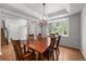 Elegant dining room boasts a large window and a chandelier, creating a warm and inviting atmosphere for gatherings at 1564 S Uinta Way, Denver, CO 80231