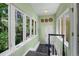 Bright entryway featuring tile flooring, coat hooks, and large windows overlooking lush greenery at 1564 S Uinta Way, Denver, CO 80231