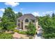 Inviting two-story home with lush landscaping, a pathway, and an arched entryway, creating an elegant and welcoming curb appeal at 1564 S Uinta Way, Denver, CO 80231
