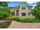 Beautiful home featuring an arched entryway, complemented by vibrant landscaping and a meticulously maintained front yard at 1564 S Uinta Way, Denver, CO 80231